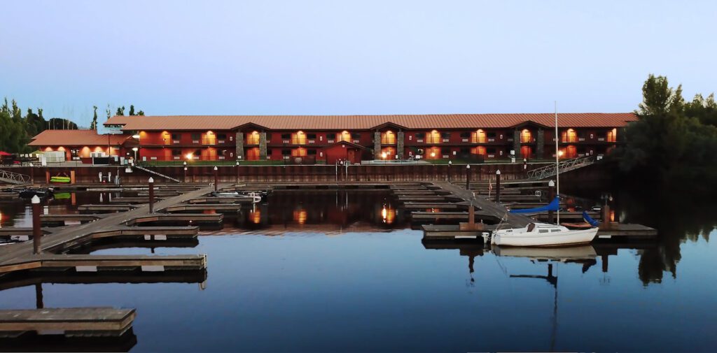 View from the water over marina looking towards docks and hotel.